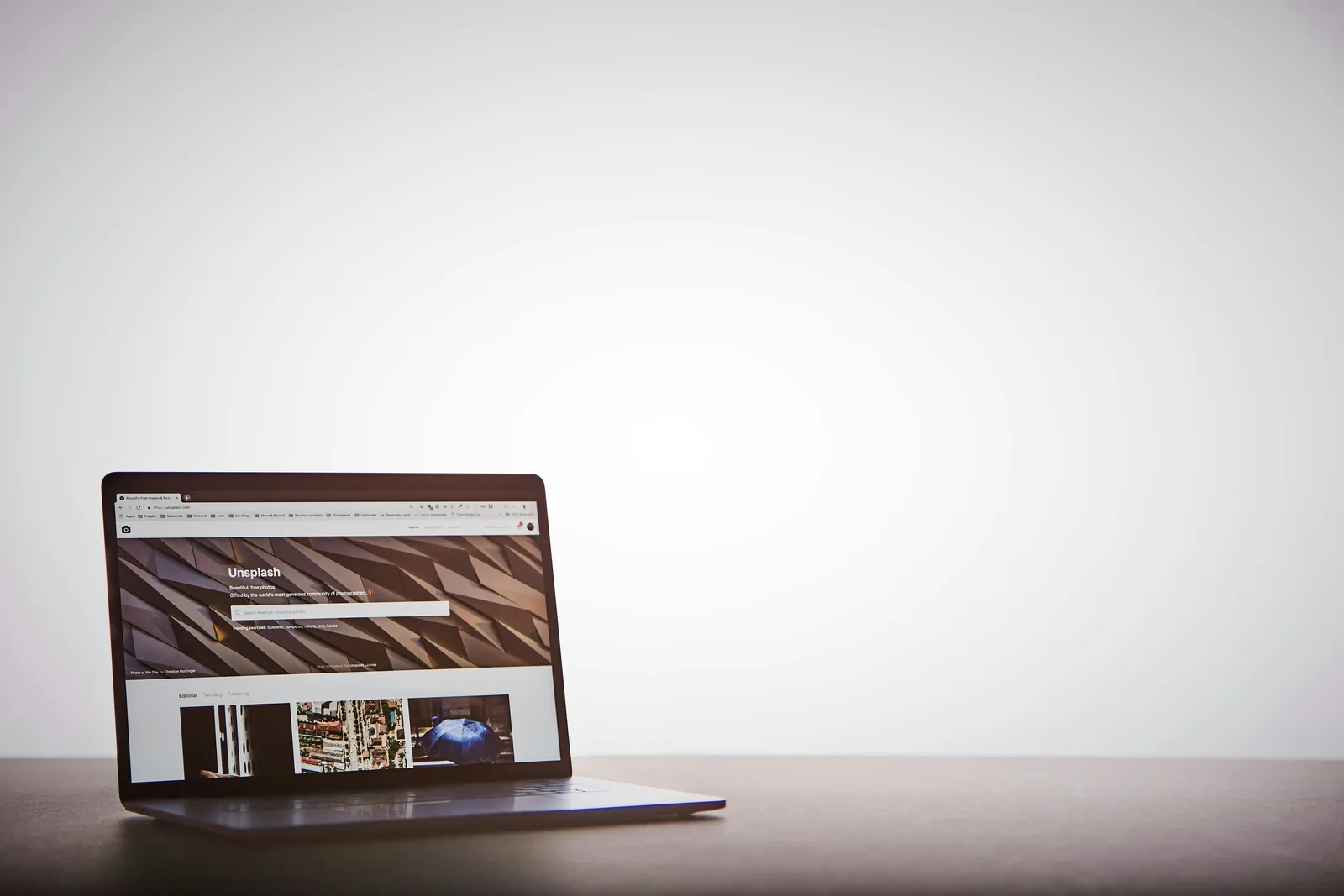 Laptop on a plain desk showing a website