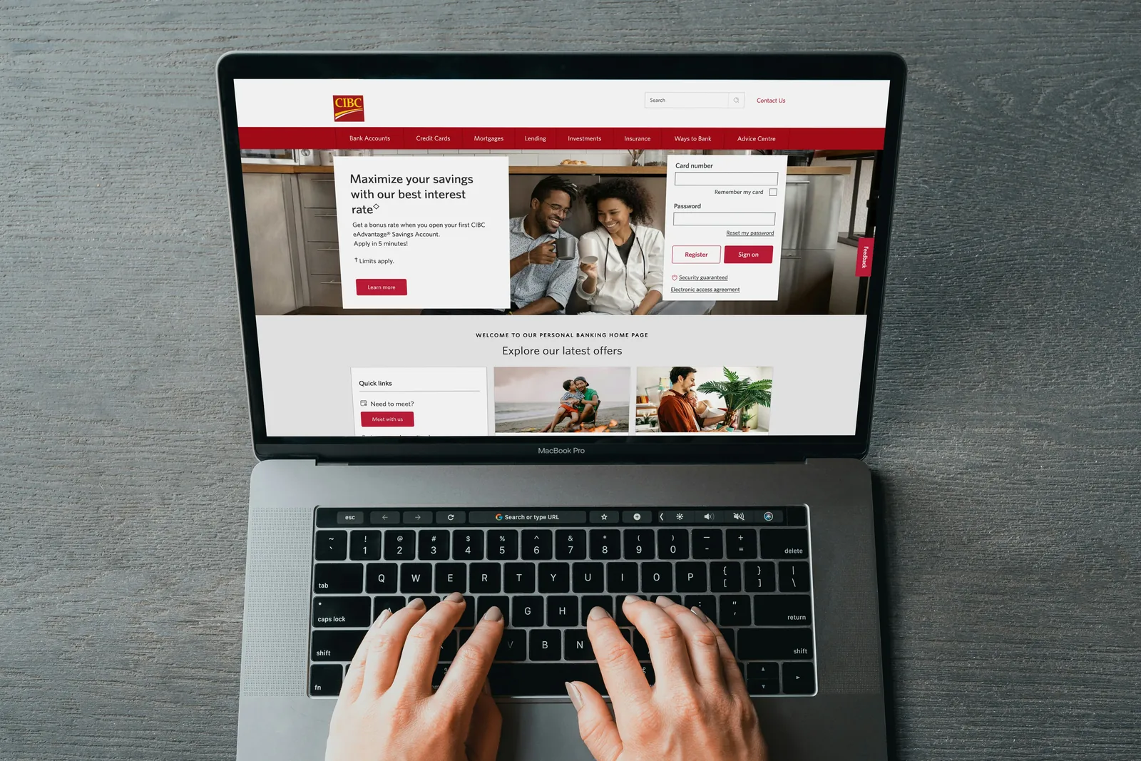 Hands typing on a laptop with a website open
